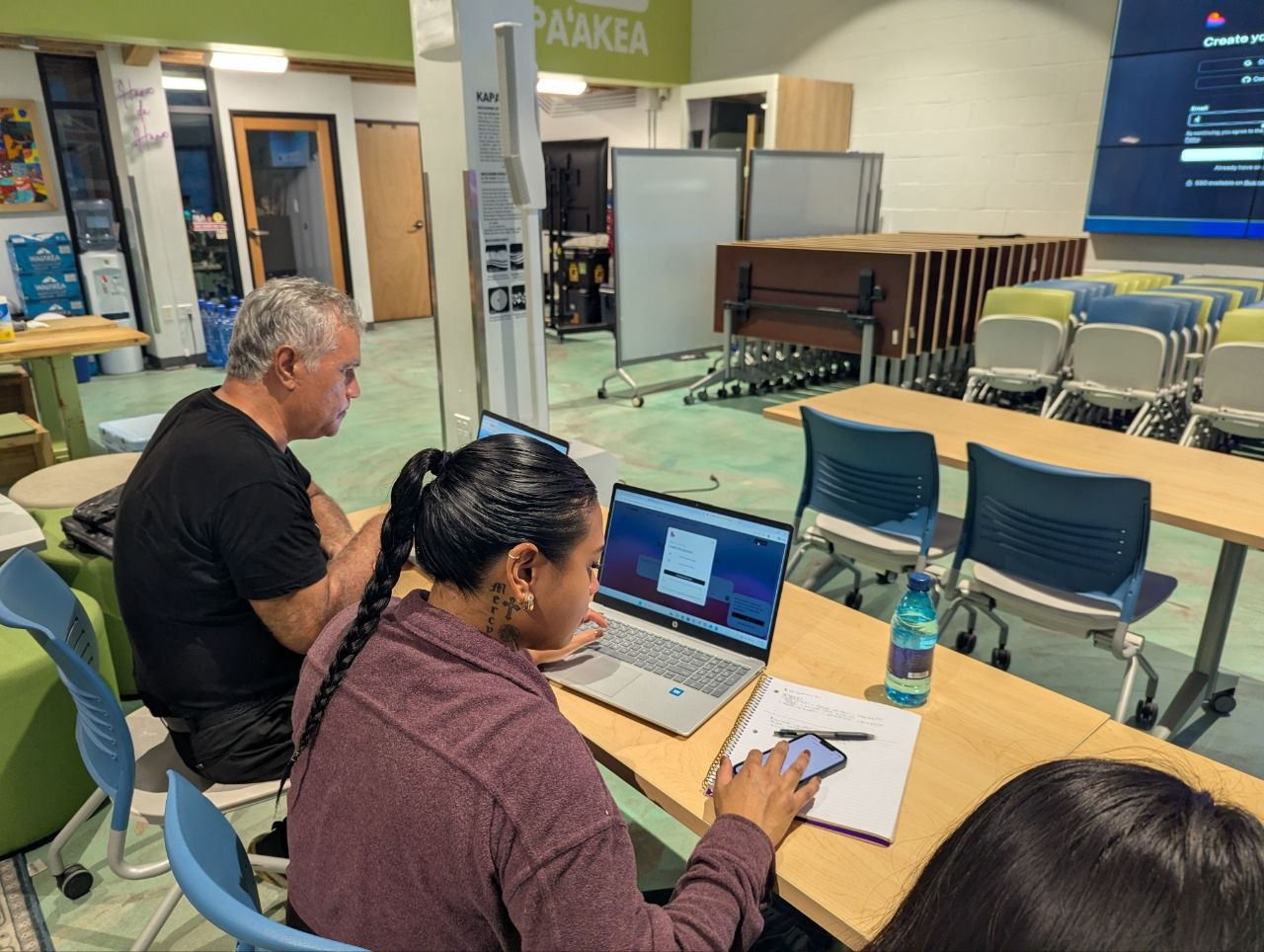 Two participants building with AI during Vibe Coding for Business